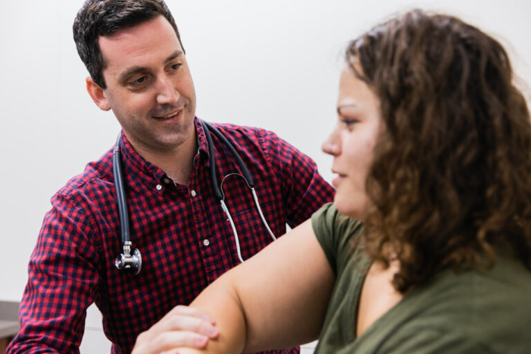 KCOA provider evaluating patient's elbow during a treatment for Orthopedic sports medicine in Kansas City