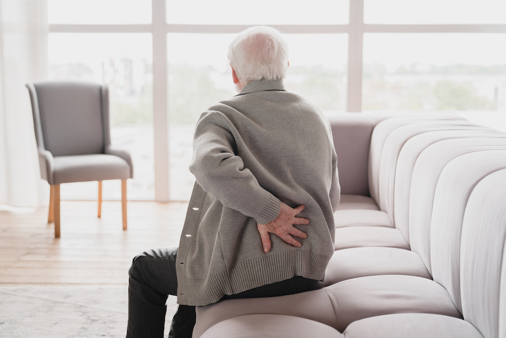 A man with back pain in need of Physiatry in Kansas City